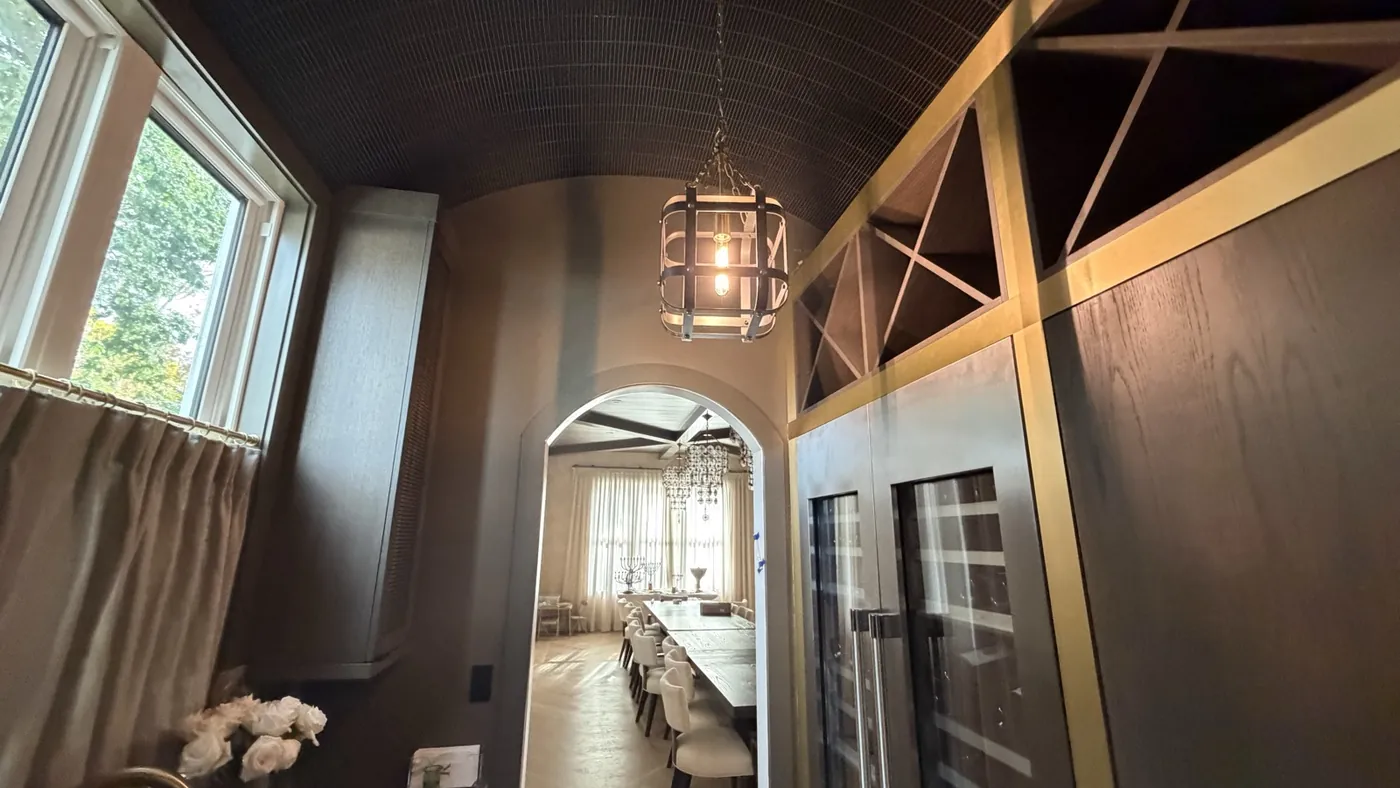Completed custom kitchen with island seating and pendant lighting.