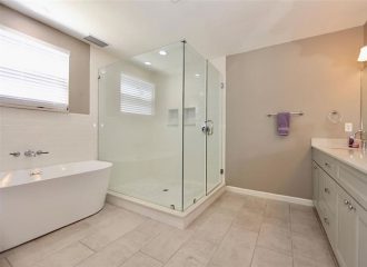 Remodeled master bathroom with a glass shower and soaking tub