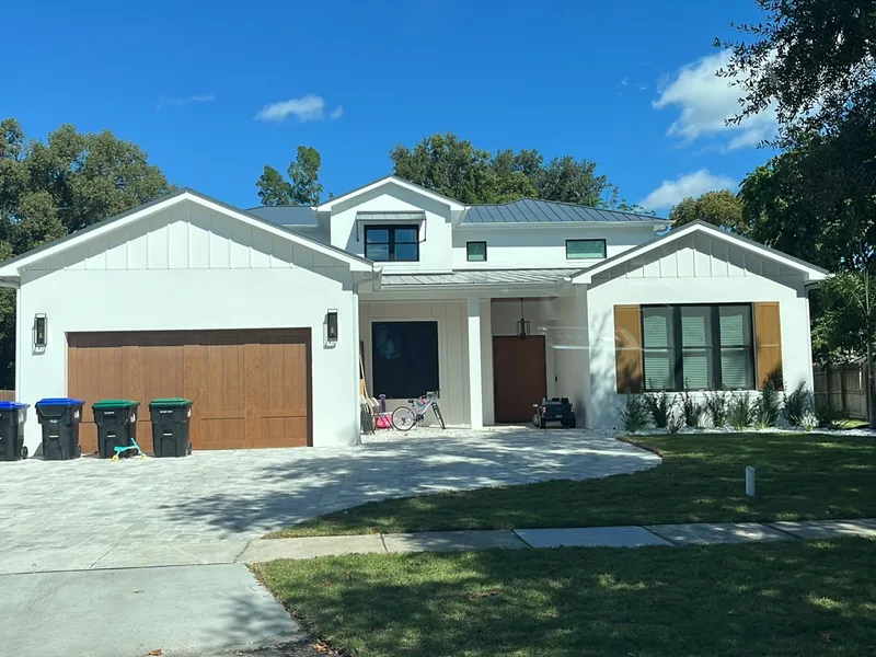 A custom home under construction with framing complete.