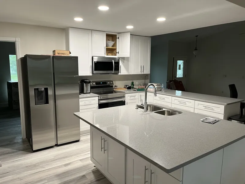 A remodeled kitchen with custom cabinetry and stone countertops.